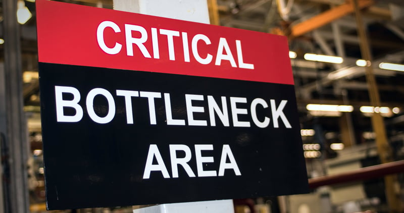 "Critical: Bottleneck Area" sign in factory
