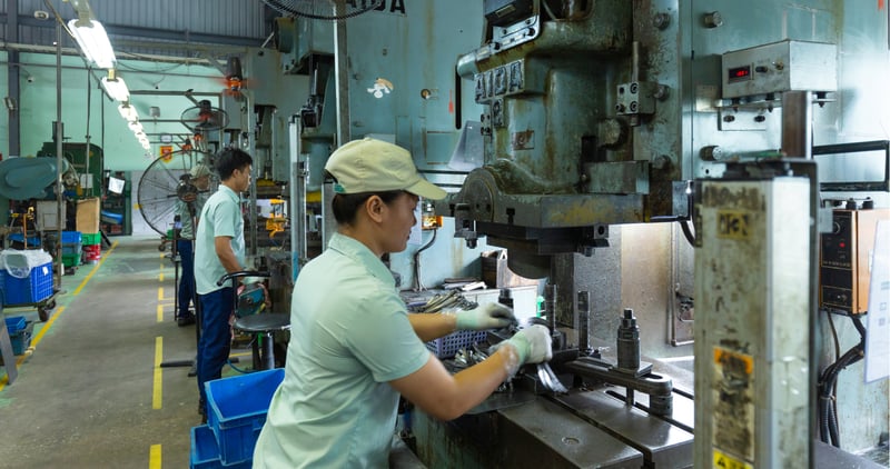 factory worker making product on a production line