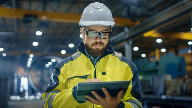 factory worker looking at tablet